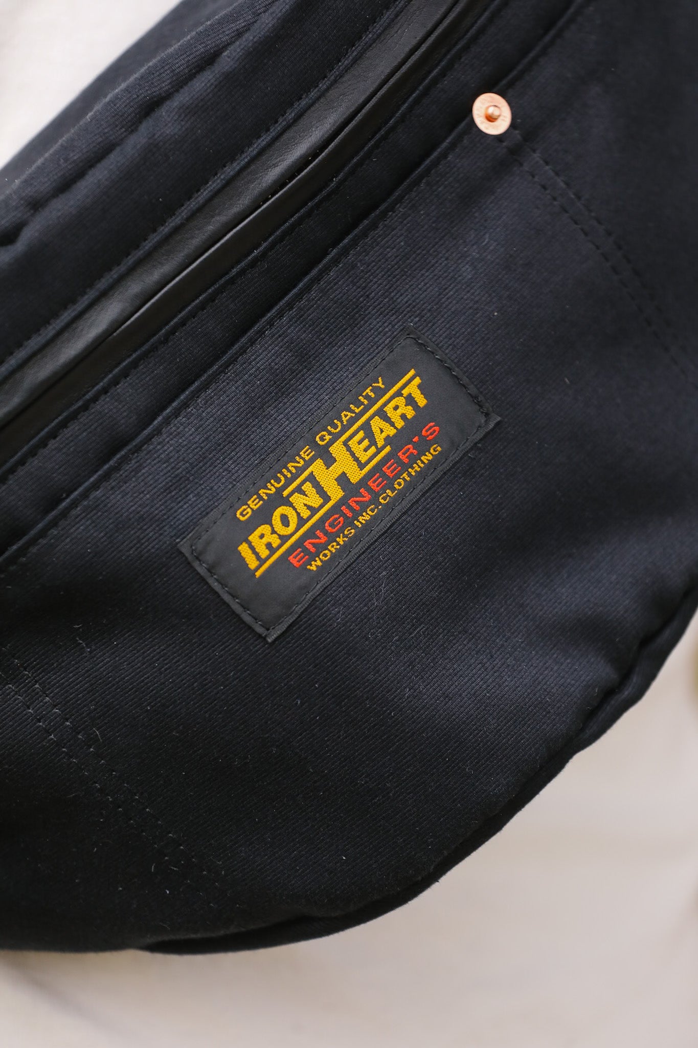 Black bag with Iron Heart label on a light background