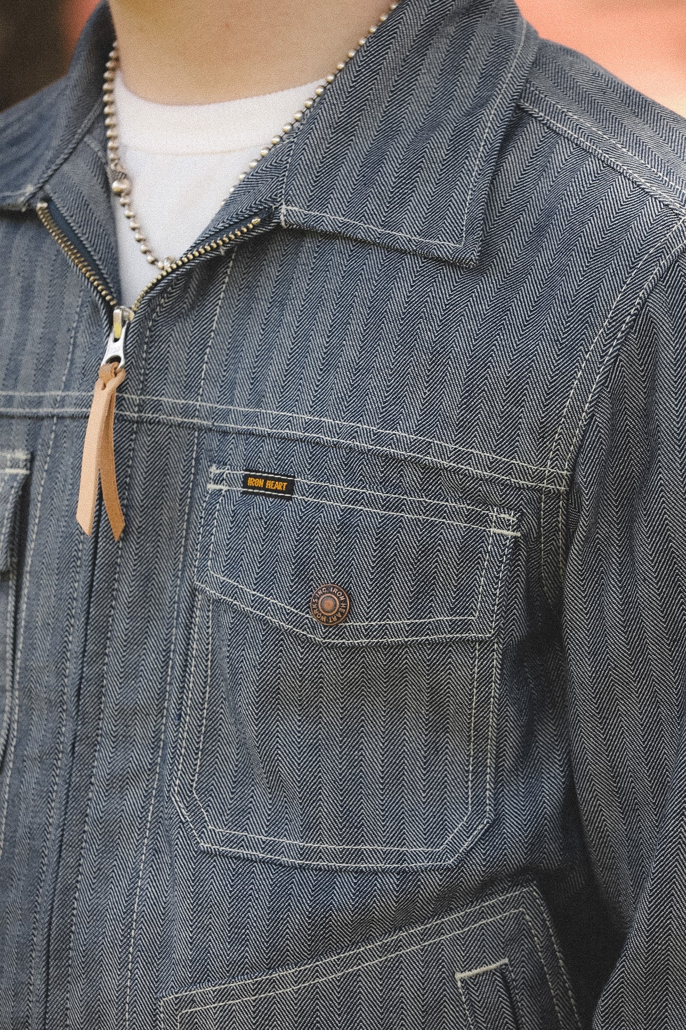 detail shot of a denim stripe jacket outdoors with a blurred background 