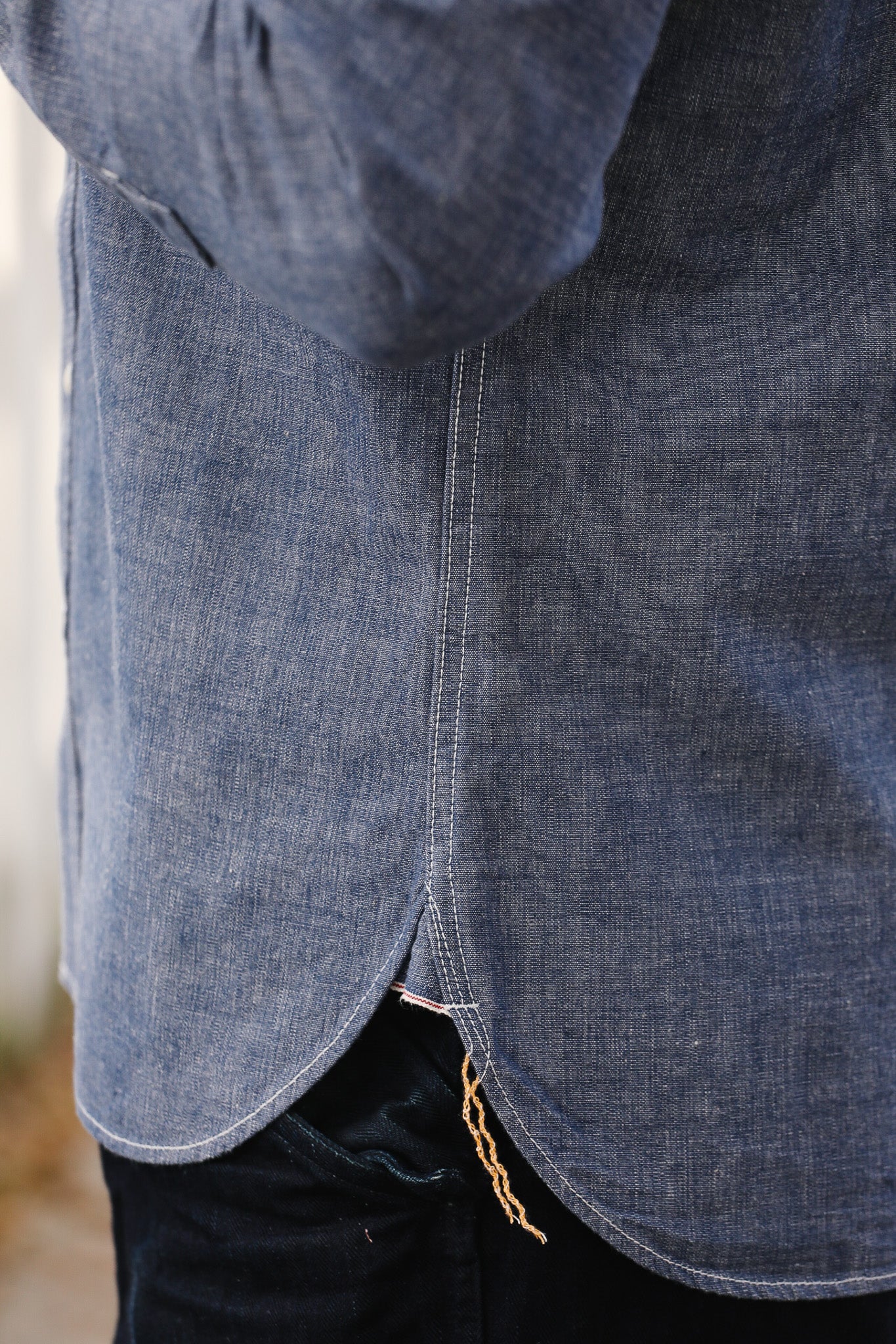 Close-up of a blue denim jacket with a blurred background