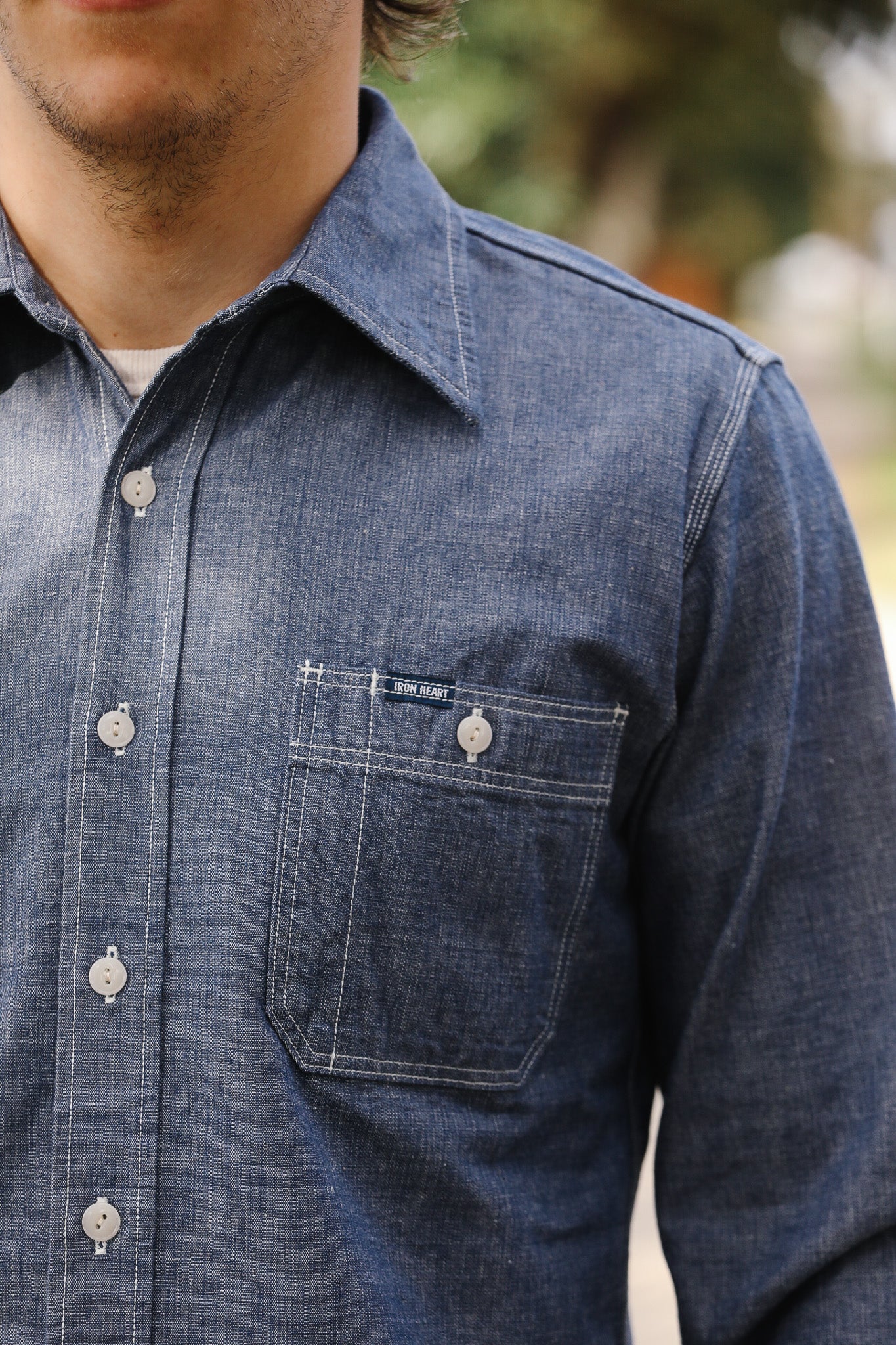 Close-up of a blue denim shirt with a blurred background