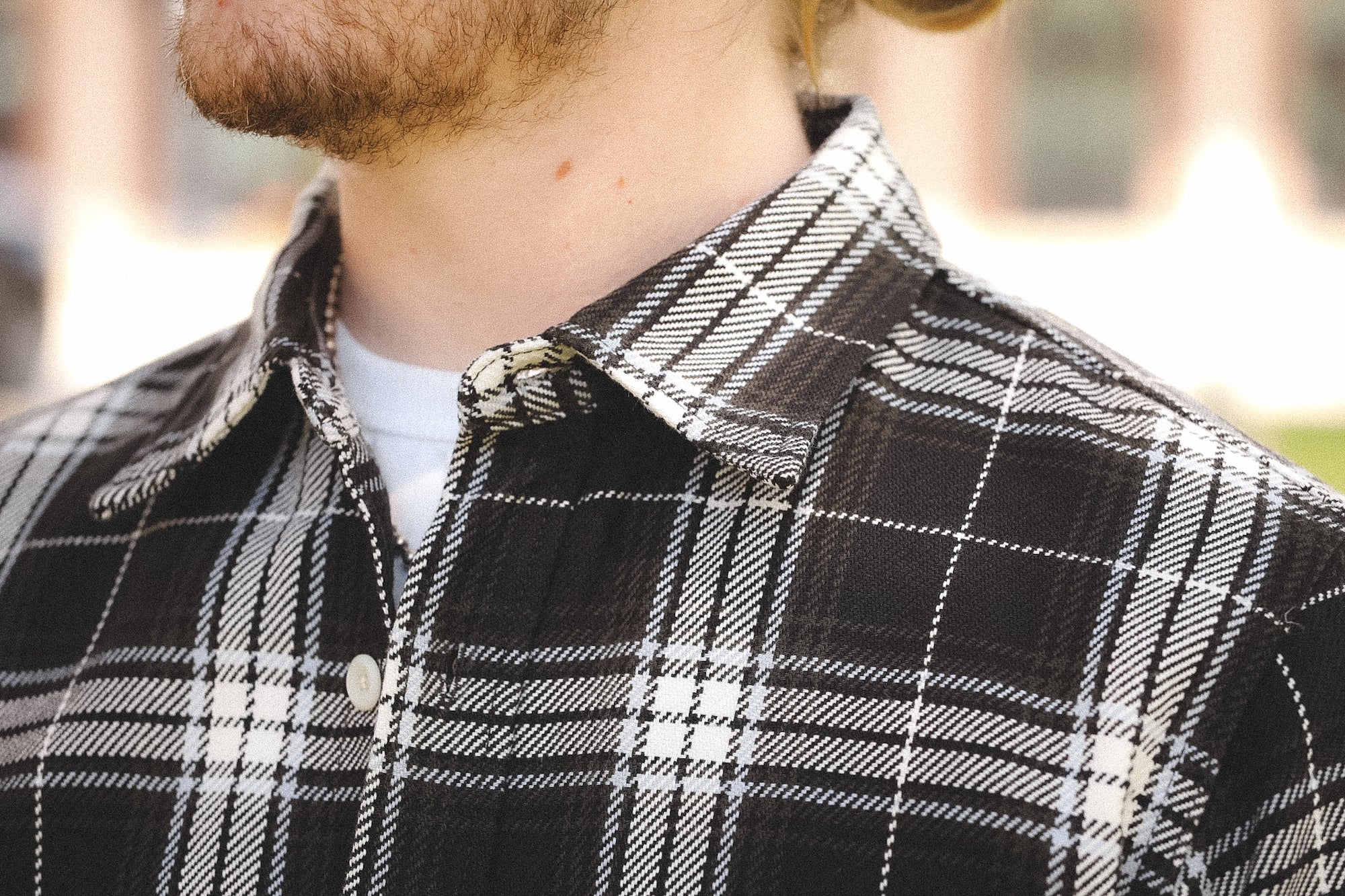 detail of plaid black shirt outdoors on a blurred background 