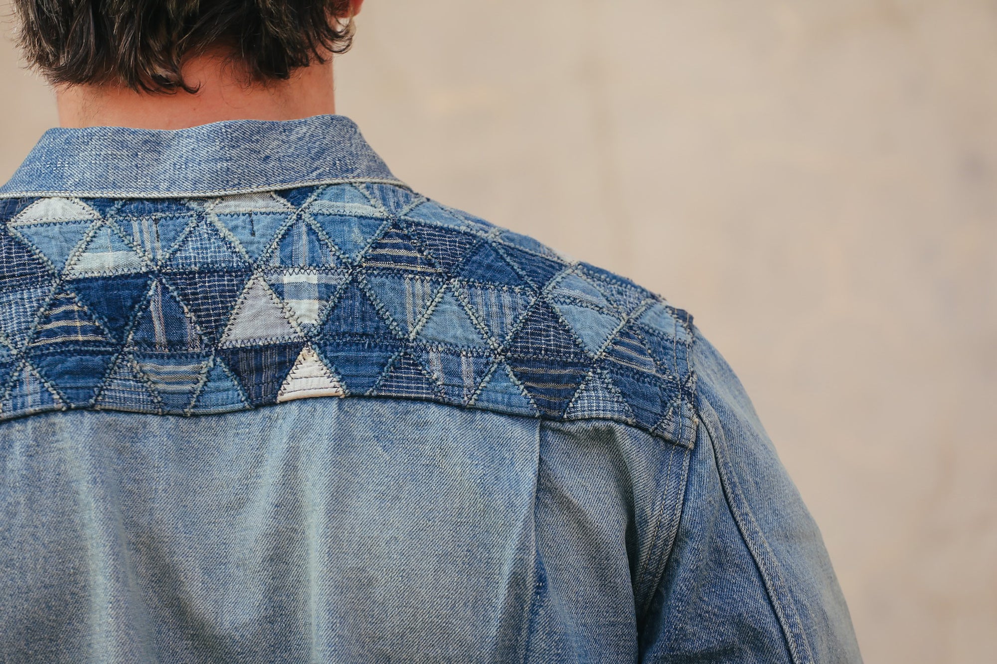 Denim jacket with geometric pattern on a neutral background
