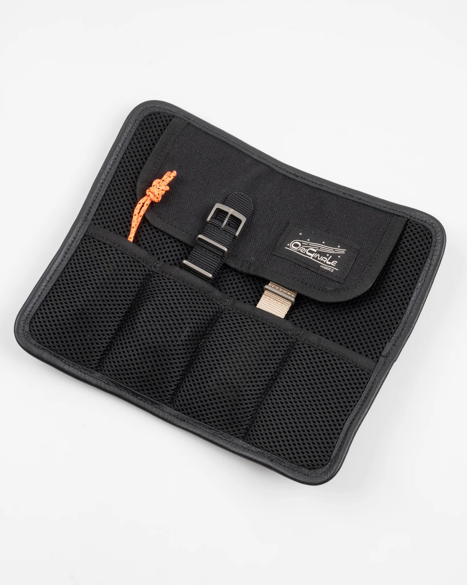 Black mesh watch roll organizer with multiple compartments holding watch straps and an orange cord