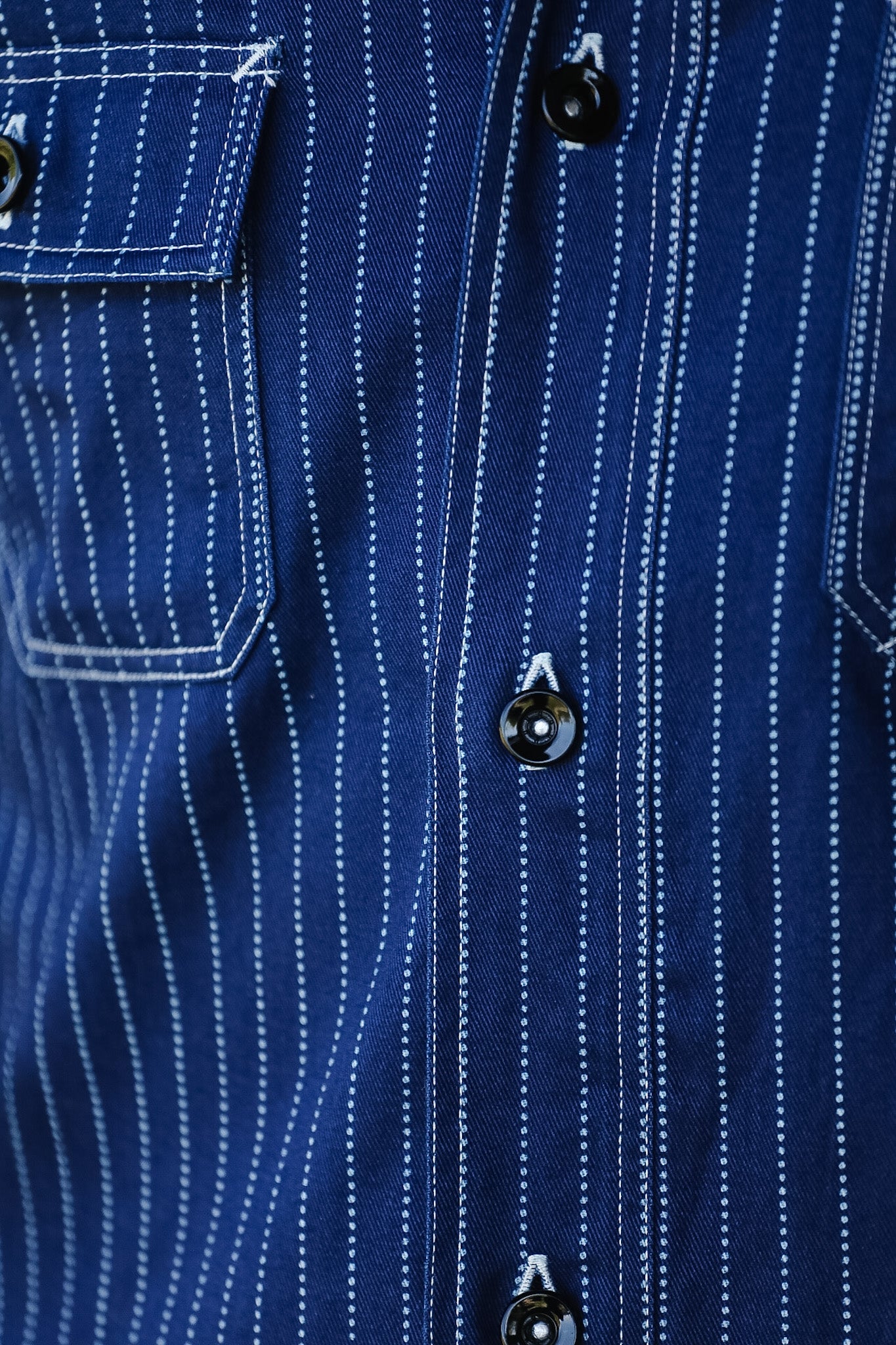 Close-up of a blue pinstripe shirt with buttons