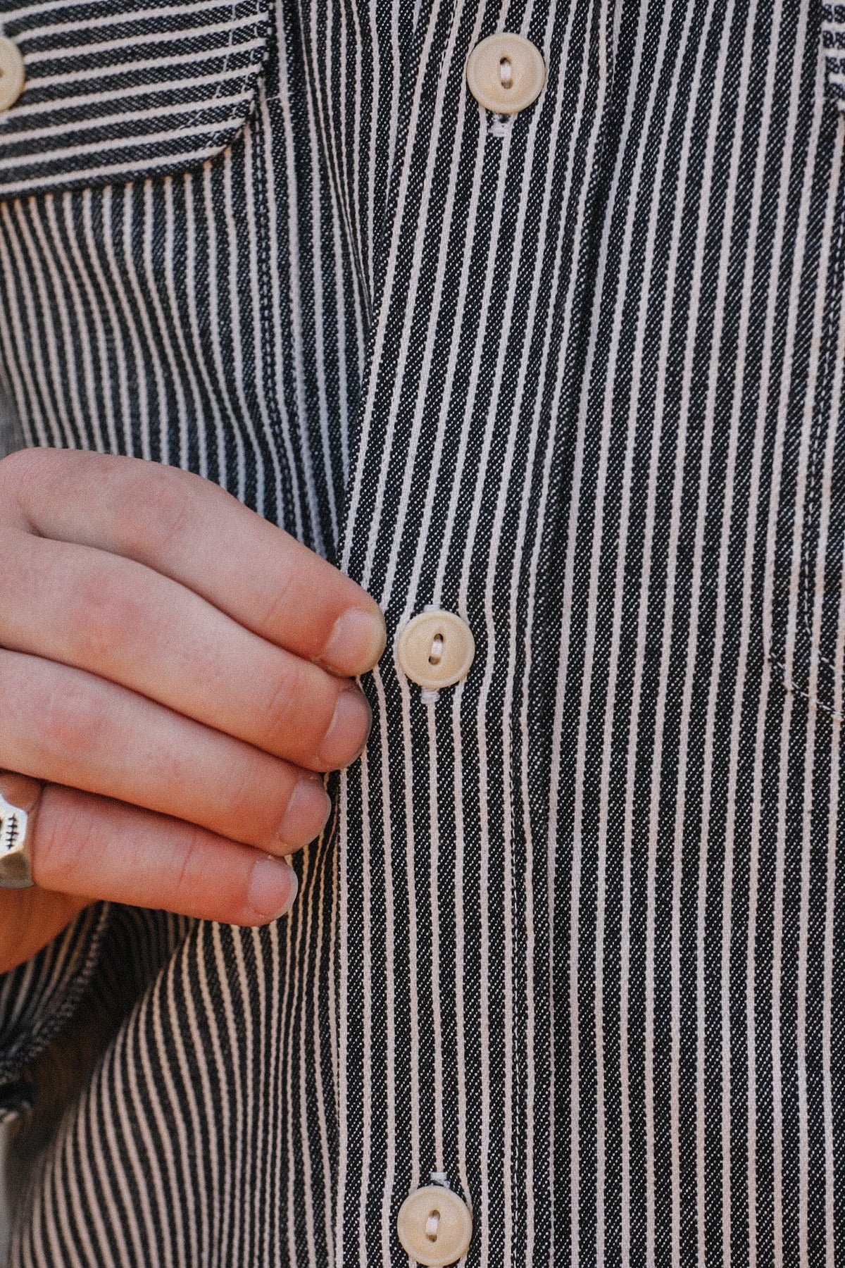 Up close detail of striped denim shirt
