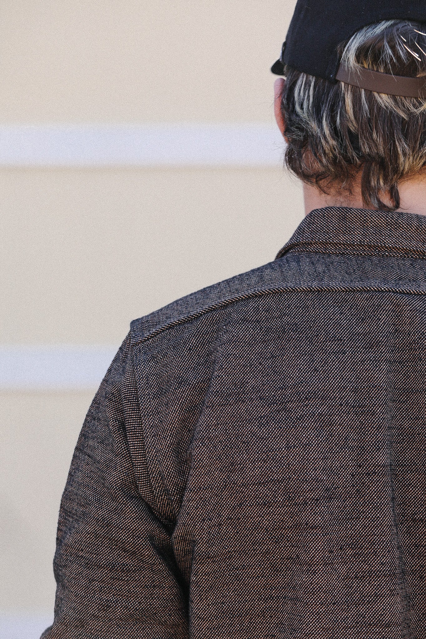 Person wearing a dark jacket with a blurred background