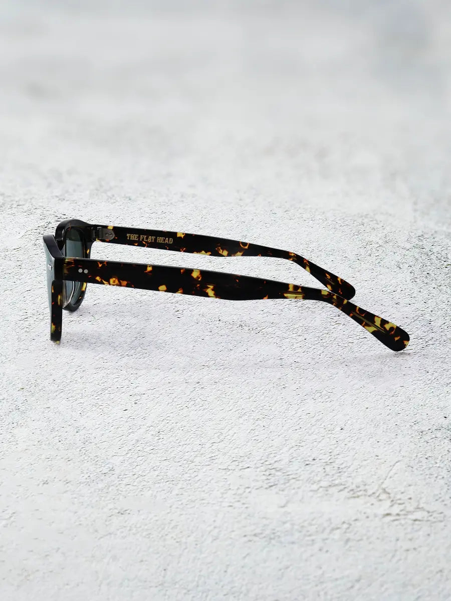 Tortoiseshell glasses on a textured white surface