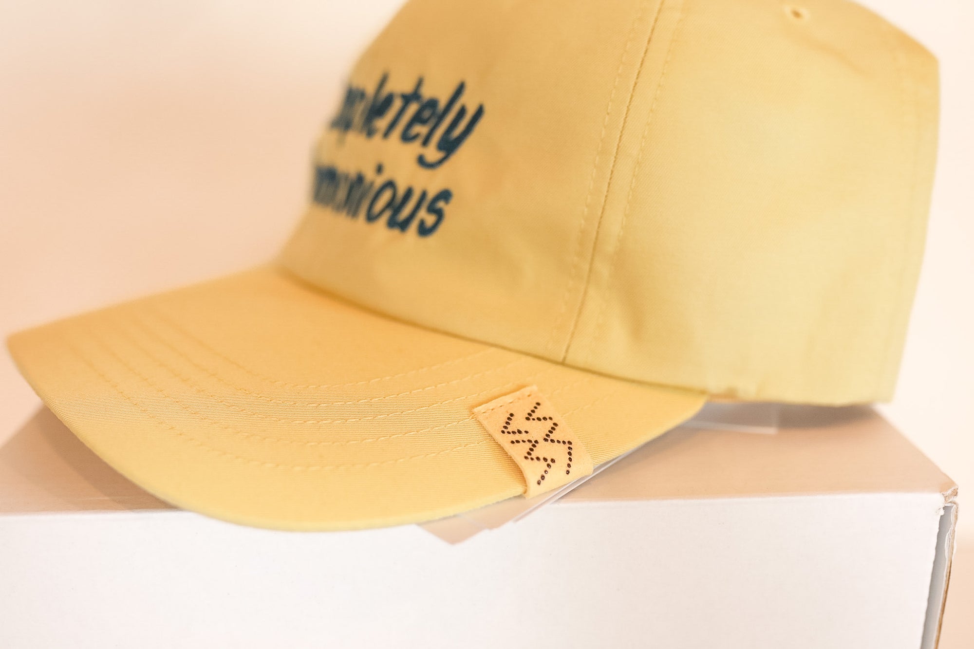 Yellow cap with text on a beige background