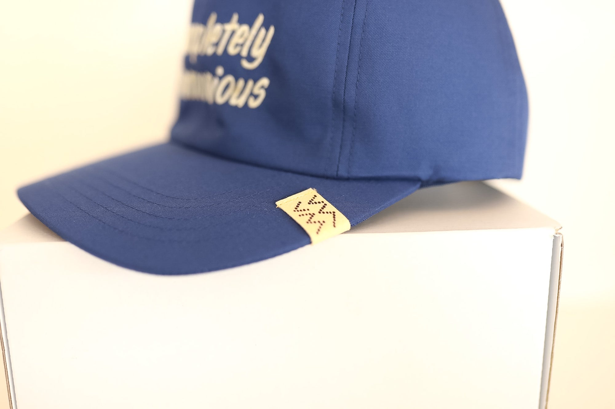 Blue cap with text on a white surface