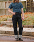 Person wearing wide straight 16.5oz Kaisen Indigo denim jeans with cuffed hems and a blue t-shirt outdoors