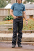 Man wearing 20oz double slub indigo wide straight jeans with a blue t-shirt and brown leather belt outdoors